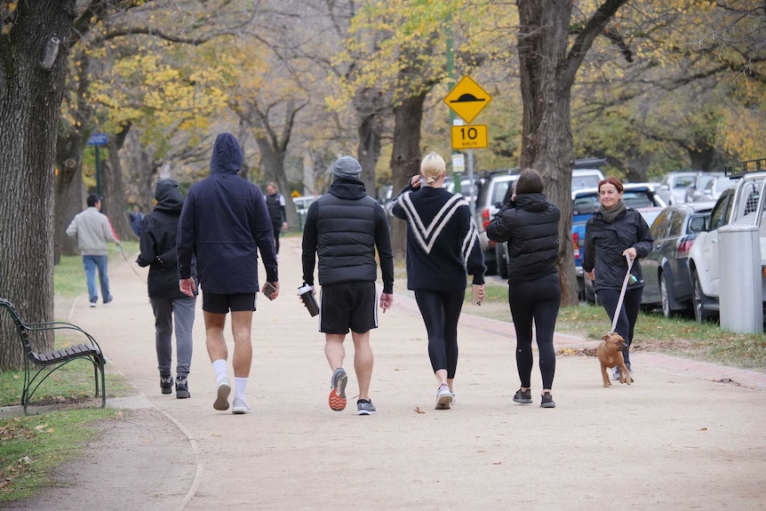 Walkers and joggers fill the Tan track on a cloudy day