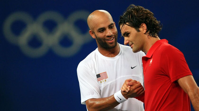 James Blake of the United States shakes hands with Roger Federer of Switzerland
