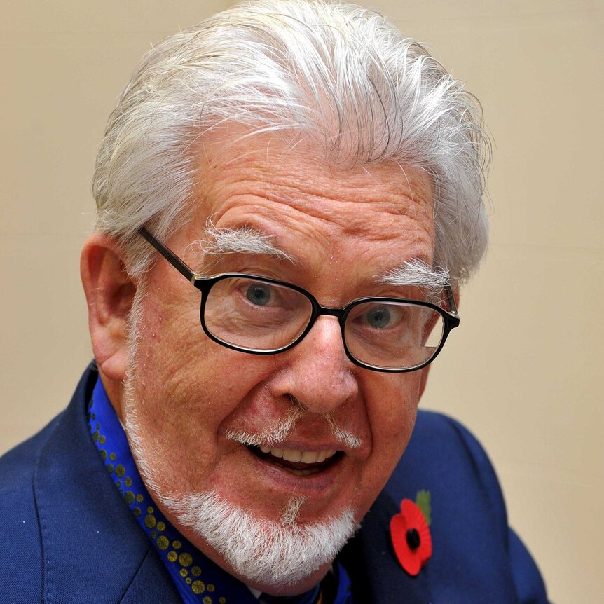 Rolf Harris poses for photos at Australia House in central London.