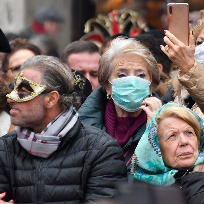 People wearing protective face masks at the Venice Carnival due to coronavirus outbreak.