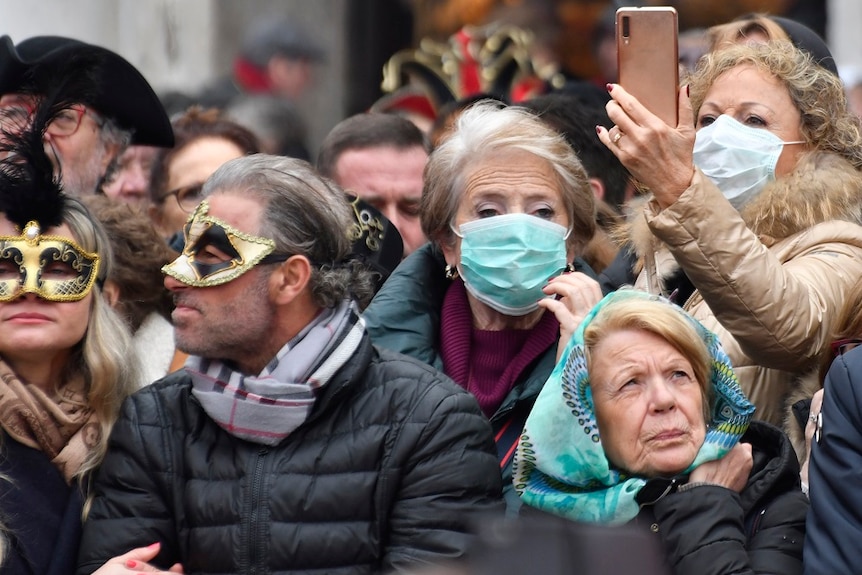 People wearing protective face masks at the Venice Carnival due to coronavirus outbreak.