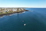 An aerial shot of a beachside community from the ocean. 