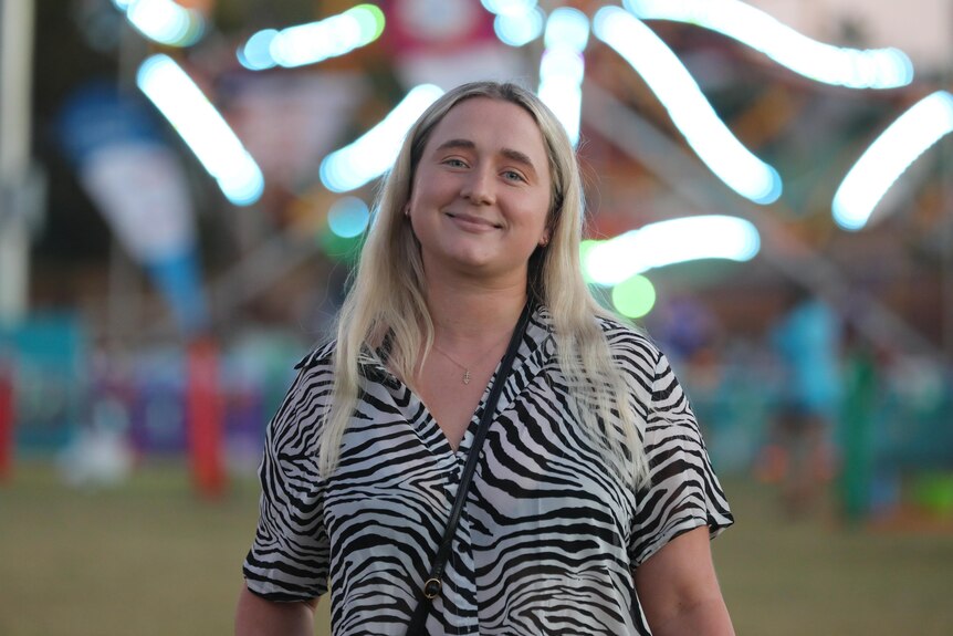 A young woman standing at a music festival