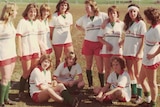 A women's soccer team from the 1970s wearing white shirts with red shorts and green socks