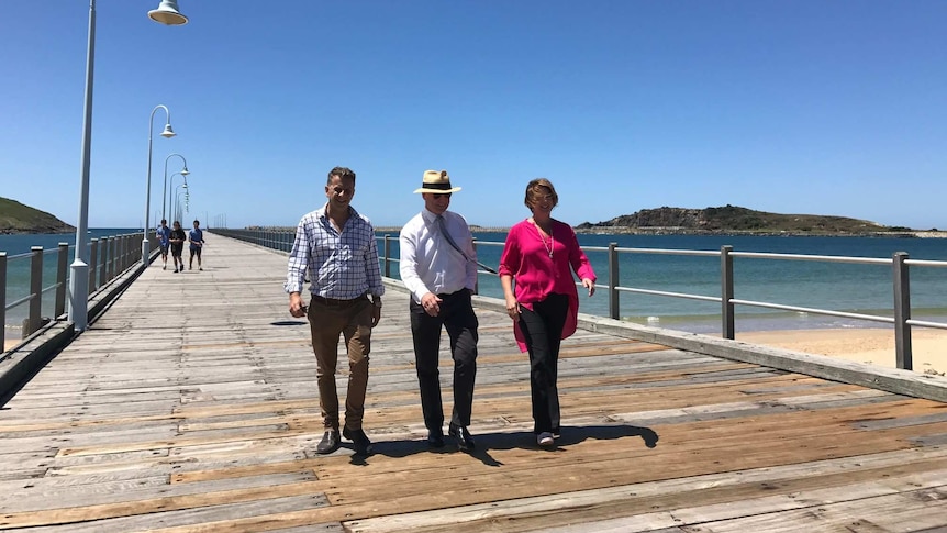 NSW politicians Andrew Constance and Andrew Fraser wal along the Coffs Harbour timber jetty with Roads Minister Melinda Pavey.