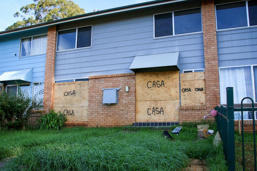 A house next door to Blake Barnes' are boarded up with the word 'casa' spray painted on the boards.