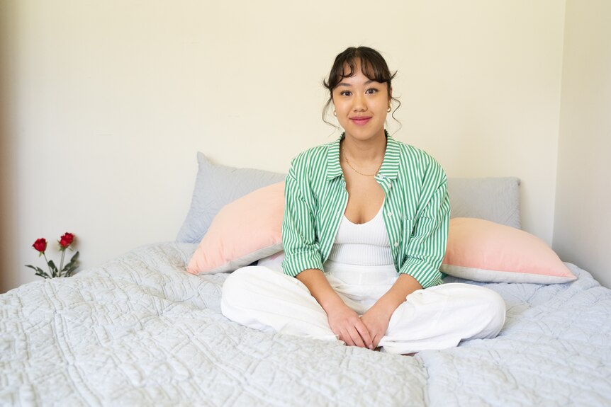 A woman sitting on a bed