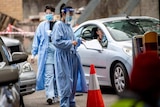 Two people wear protective clothing