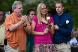 Mourners attend a vigil for the victims of Aurora mass shooting