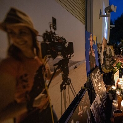 Wreaths and pictures of cinematographer Halyna Hutchins at a memorial