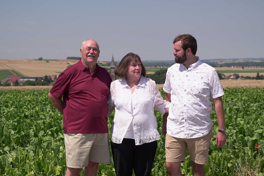 Mark, Laurie and David DeMoss standing in a field at Hamel