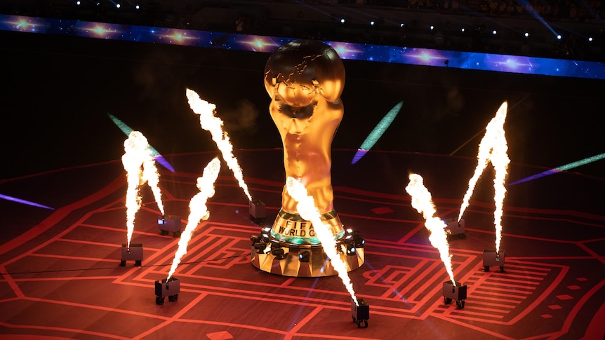 Flame throwers go off around a replica of the FIFA World Cup trophy.