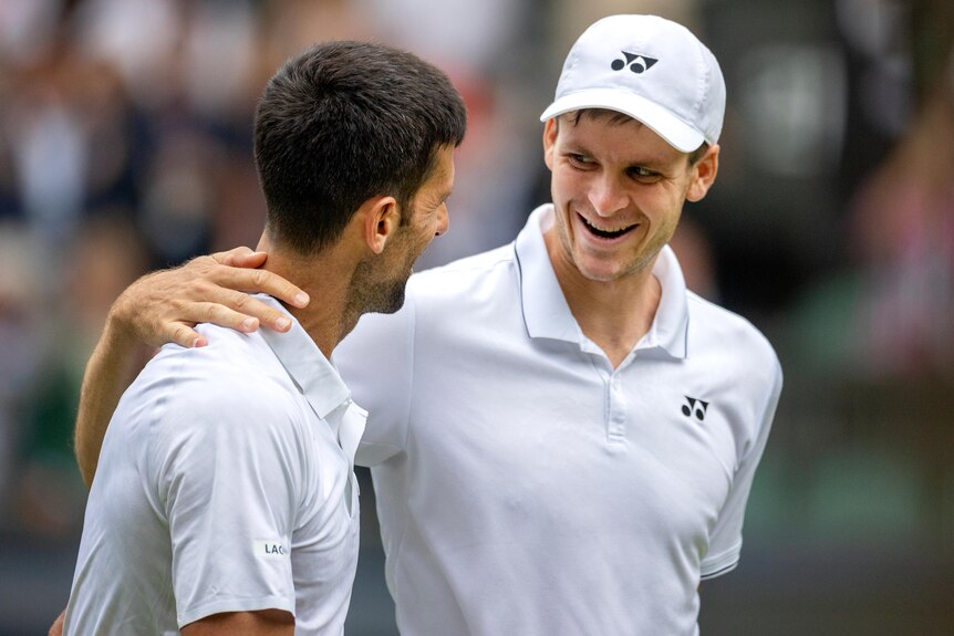 Novak Djokovic and Hubert Hurkacz share a hug.
