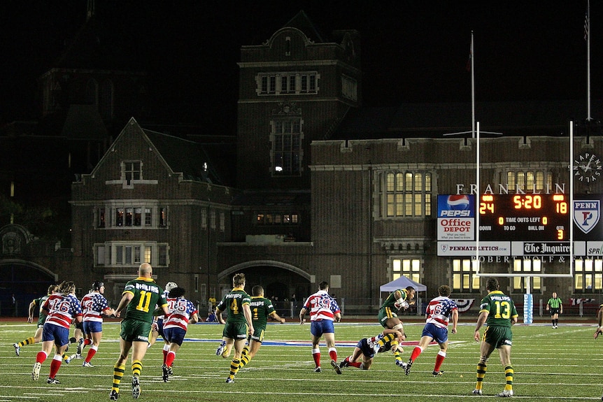 Two rugby league teams play on a gridiron field