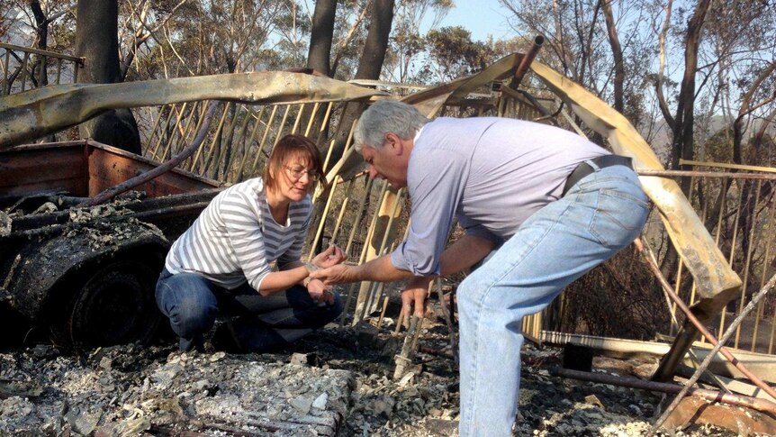 Winmalee residents sift through the remains of their home.