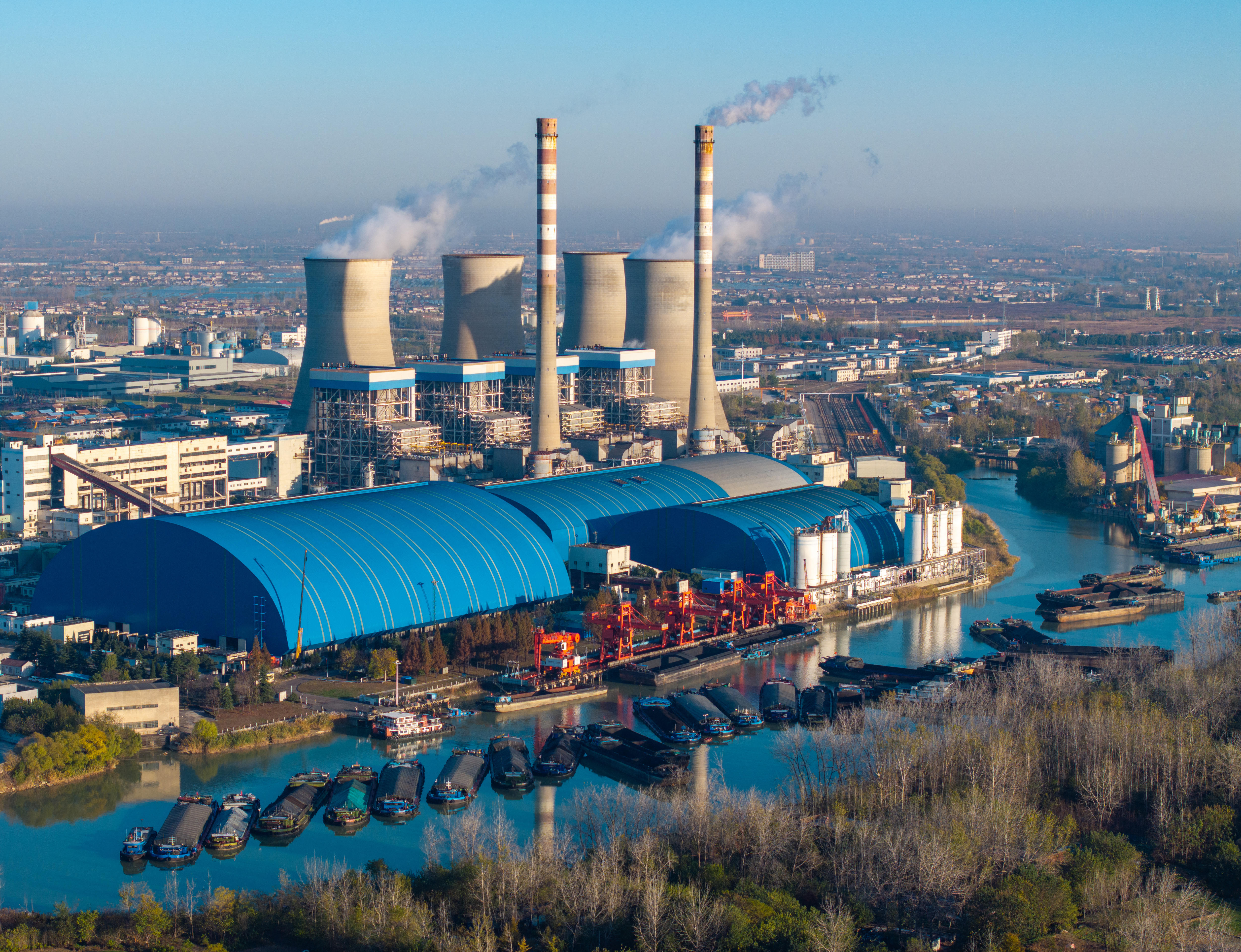 Chimneys and cooling towers emit smoke and vapor at a power station.