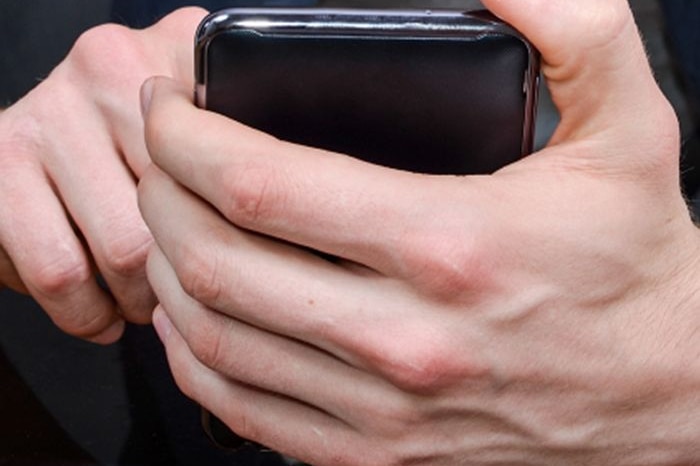 A man holding a mobile phone.