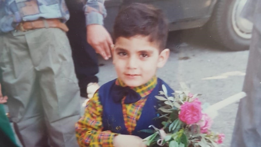 Fadi Chalouhy holding flowers as a child