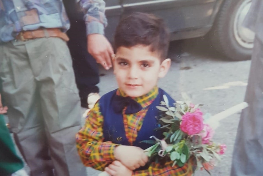 Fadi Chalouhy holding flowers as a child