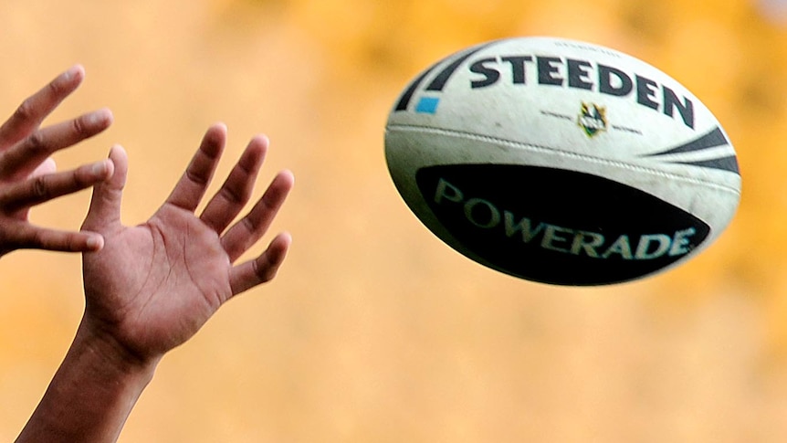 An NRL player catches a ball during training.