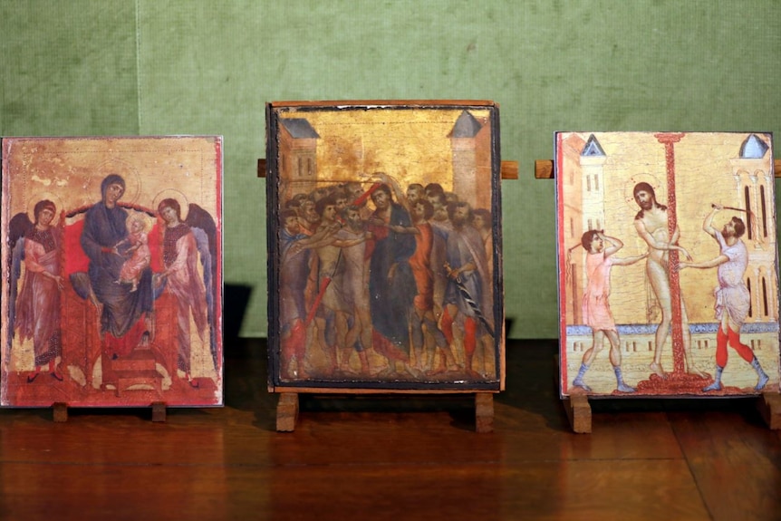 The painting Christ Mocked sits between two copies of other artworks by Cimabue.