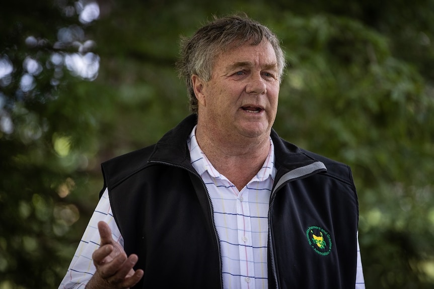 A man wearing a TFGA vest fronting the camera to talk rural issues in Tasmania