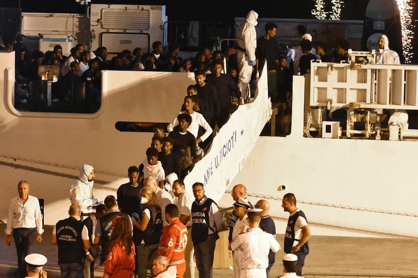 Migrants disembark from the Italian Coast Guard ship "Diciotti".