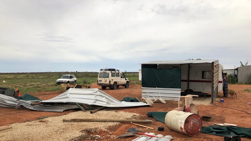 Image of wreckage from transportable building strewn across the ground after a freak storm.