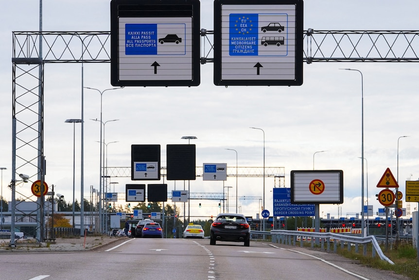 Cars drive through a border crossing between Finland and Russia.