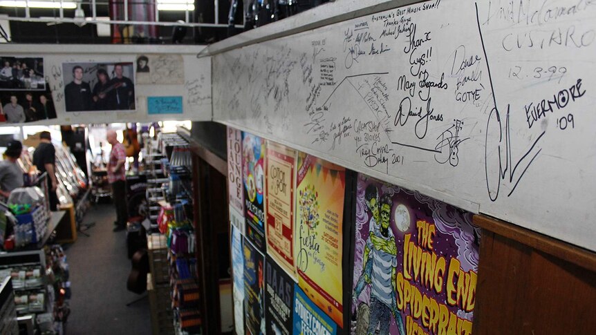 Autographs on a wall in a music store.