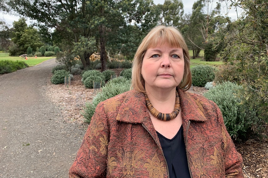 Rosanna Coombes stands in a landscaped garden.