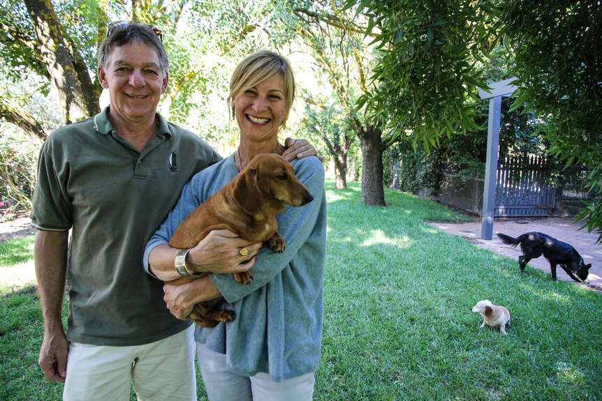 Farmer David Mathews and his wife local accountant Sam Mathews in their front yard with their three dogs.