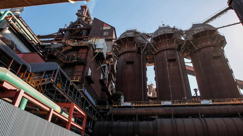 Three large stacks and associated heavy machinery.