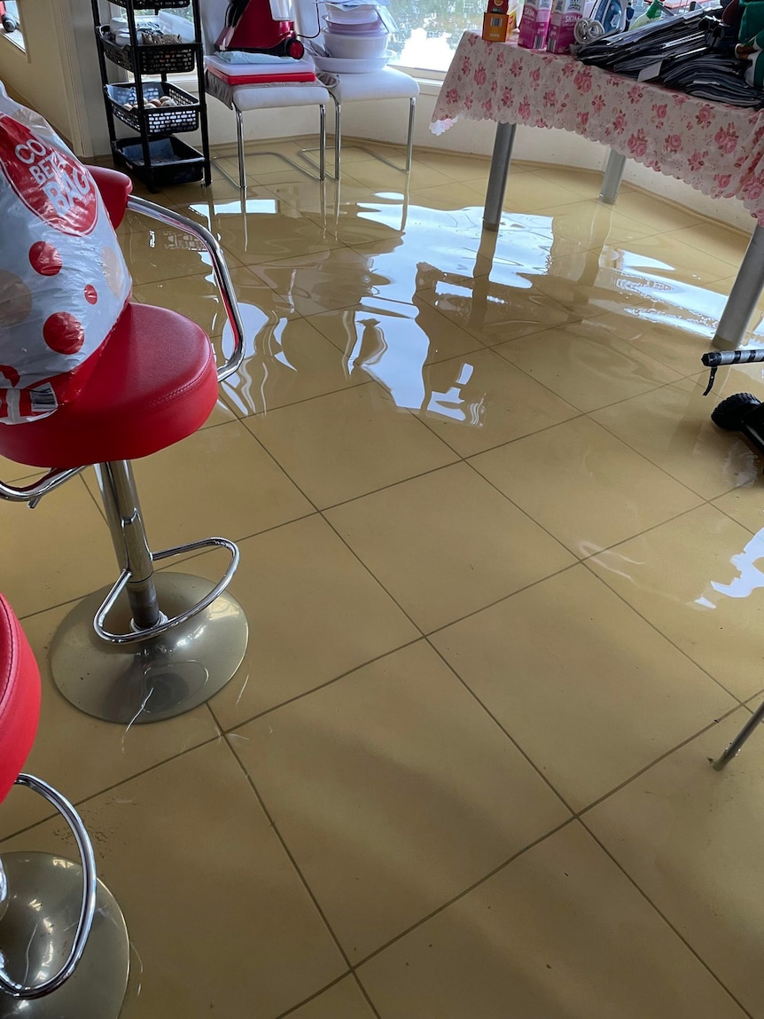 Floodwaters cover a kitchen floor.