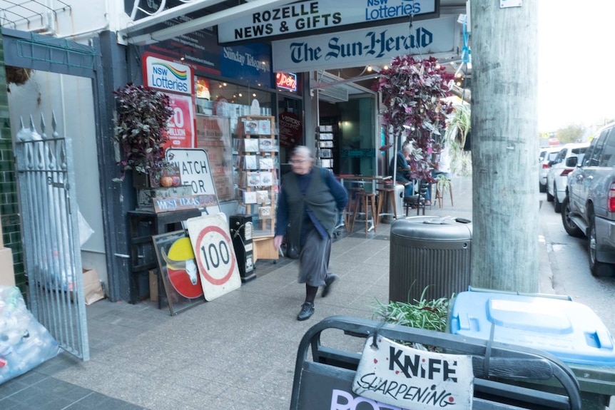 A woman walks past a newsagents in Rozelle