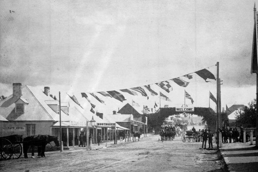 A black and white image shows the town of Tenterfield's main street in 1886. 
