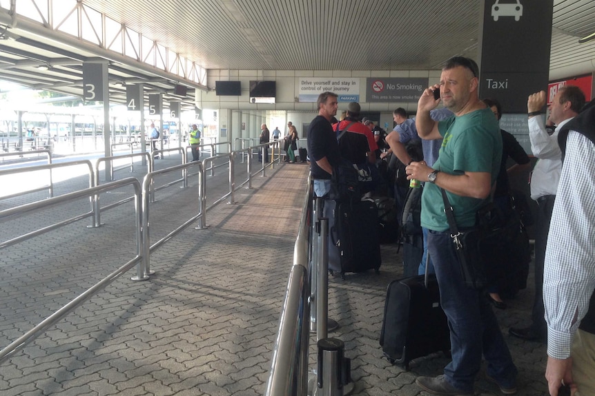 A line of passengers wait for taxis at Perth airport