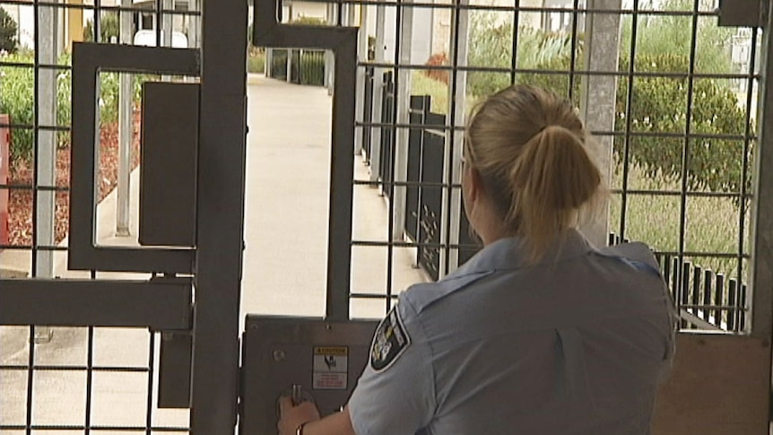 ACT Corrections officer at a gate within Canberra's jail - the Alexander Maconochie Centre. Taken February 04, 2014.