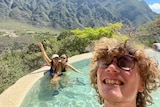 Tallis takes a selfie in an outdoor mountain pool with two friends.