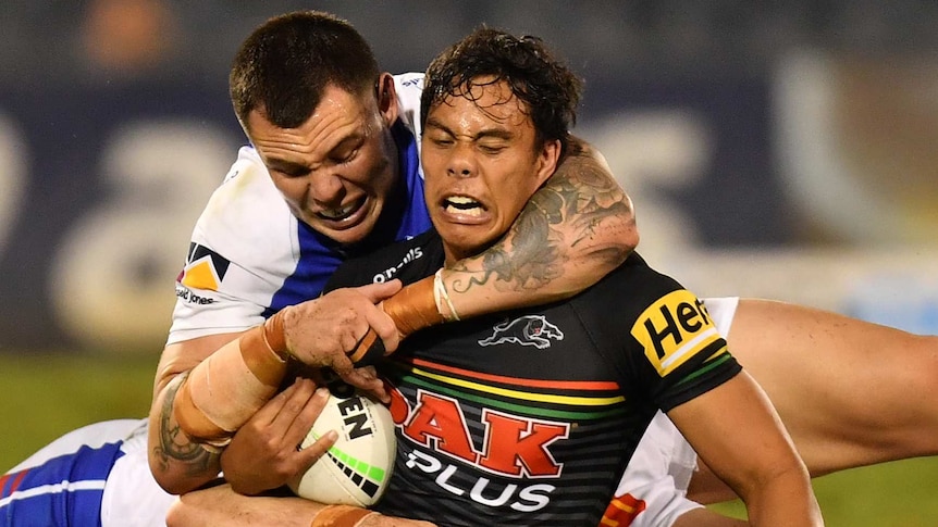Jarome Luai of the Panthers is tackled by David Klemmer and Aidan Guerra of the Knights during their NRL clash.