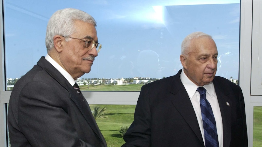 Ariel Sharon (right) shakes hands with Palestinian leader Mahmoud Abbas at a peace summit in Egypt.