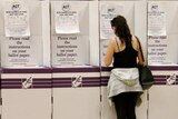 A person voting at a booth in the ACT election