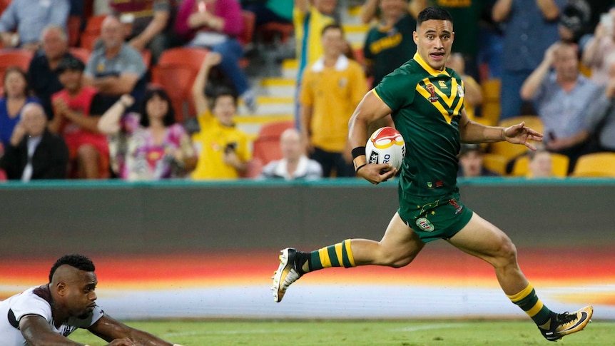 Valentine Holmes of the Kangaroos scores a try against Fiji at the Rugby League World Cup.