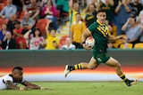 Valentine Holmes of the Kangaroos scores a try against Fiji at the Rugby League World Cup.