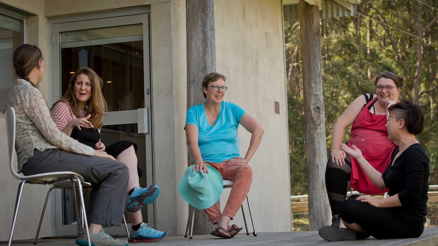 Five women talking at an art retreat