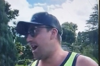A man wearing a hi-vis singlet, cap and sunglasses is captured on CCTV footage