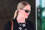 A woman in sunglasses leaves the Brisbane Magistrates Court