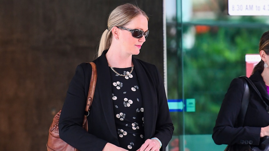 A woman in sunglasses leaves the Brisbane Magistrates Court
