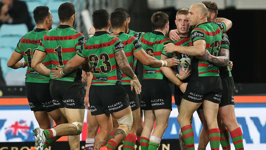 Rabbitohs' Aaron Gray celebrates his try with team-mates against Manly.