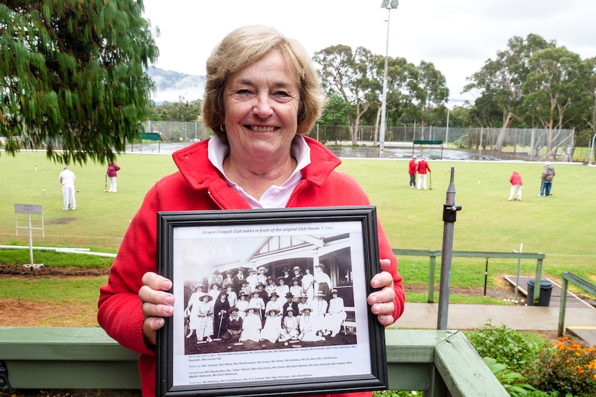 Ms James holds a photograph